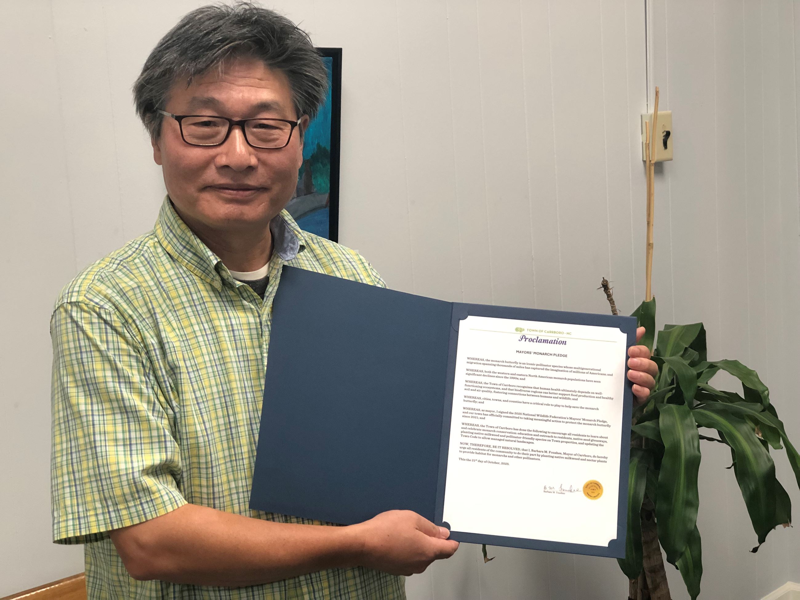 Xilong accepting the Mayor’s Monarch Pledge Proclamation